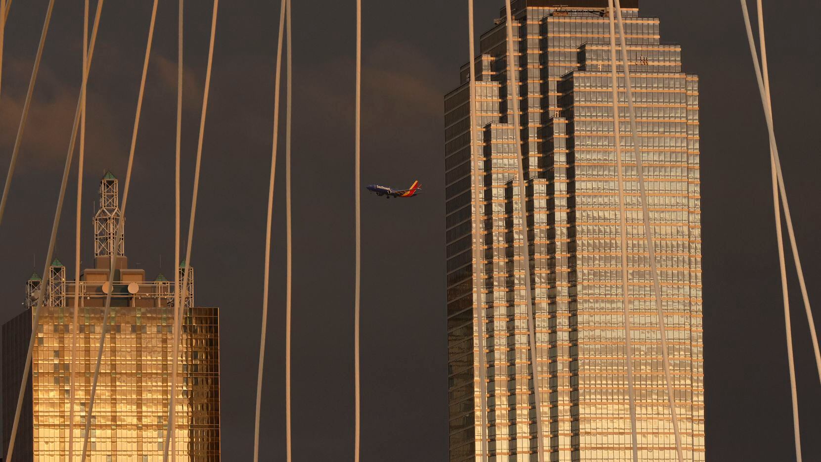 A Southwest Airlines jet makes its approach to Dallas Love Field as it crosses downtown Dallas.
