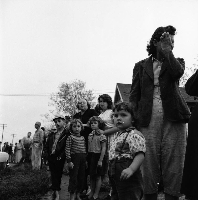Dallas residents line the streets after a deadly F3 tornado hit the city on April 2, 1957....