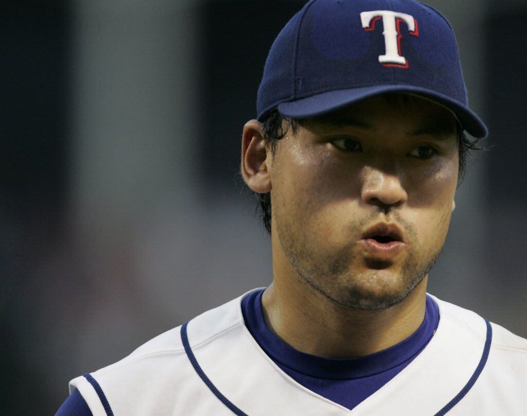 Texas Rangers starting pitcher Chan Ho Park lets out a sigh after getting out of the fifth...