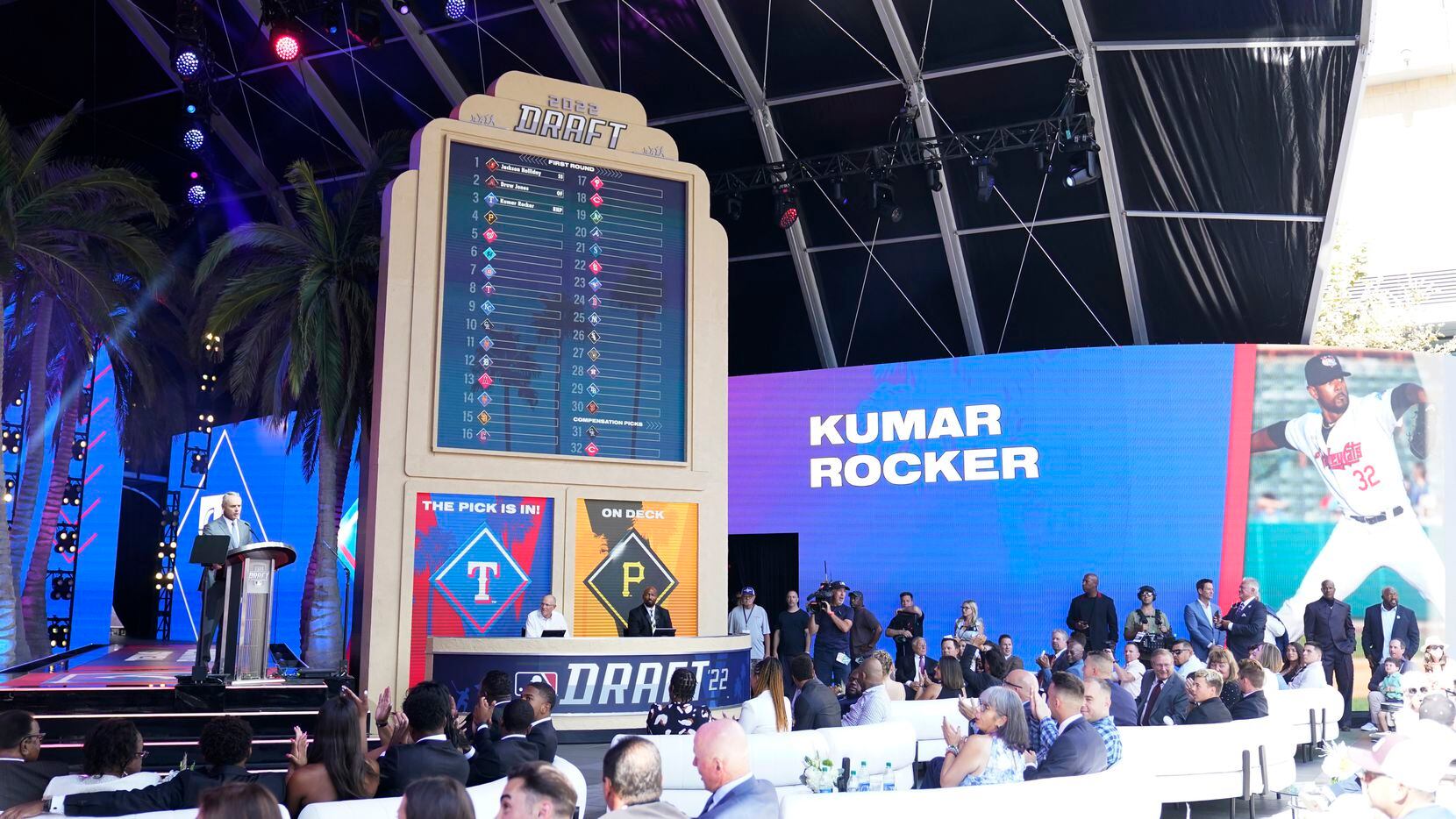 MLB Commissioner Rob Manfred, left, announces the selection of Kumar Rocker by the Texas...