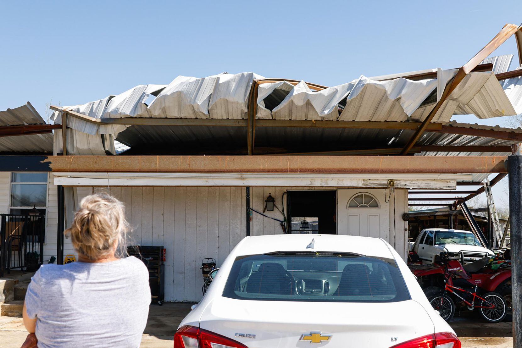 Shelia Jestes looks at the metal roof over her house in Alvarado on Tuesday, April 5, 2022,...