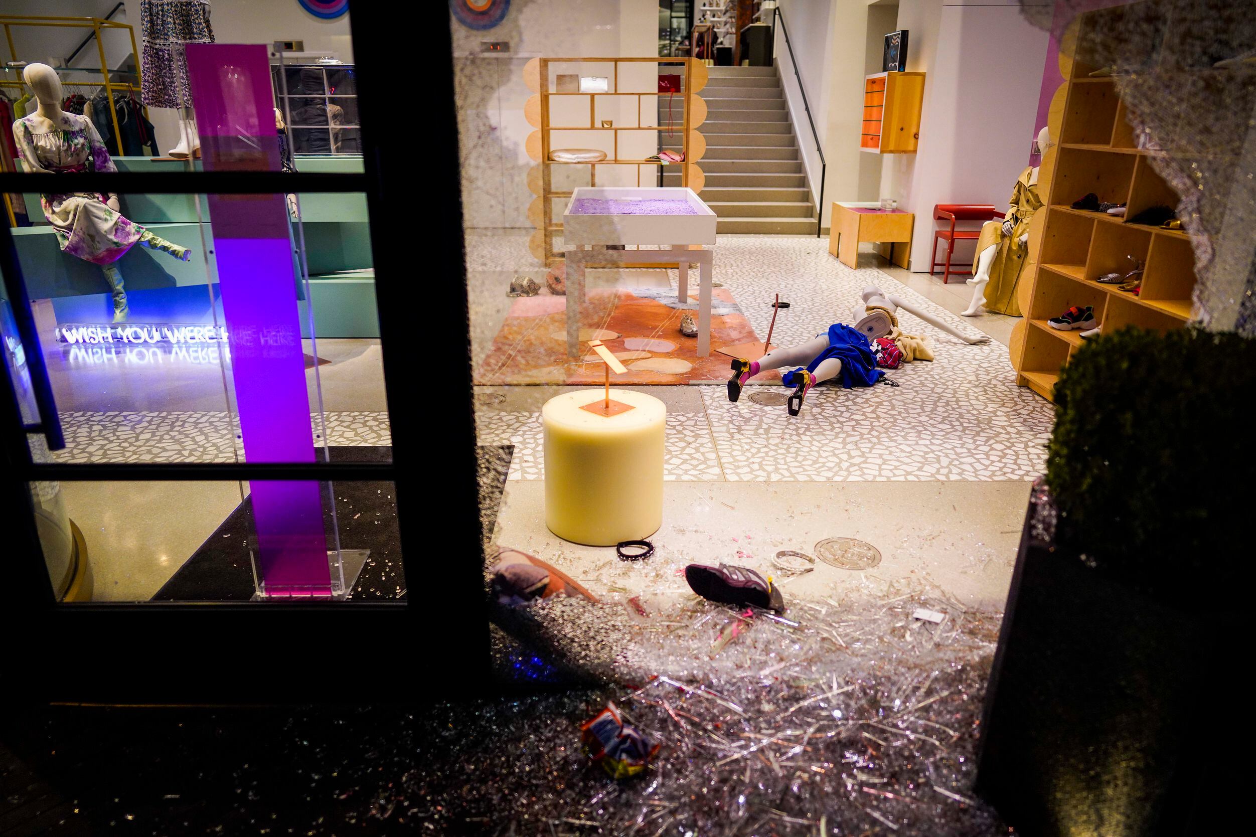 Mannequins lie amidst broken glass after windows were smashed at the Forty Five Ten store...