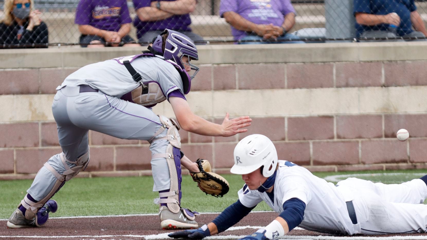 Jesuit’s David Long slides safely home to score a run ahead of Richardson catcher Marcus Peters during a district 7-6A game at Jesuit College Preparatory in Dallas, Saturday, April 24, 2021.