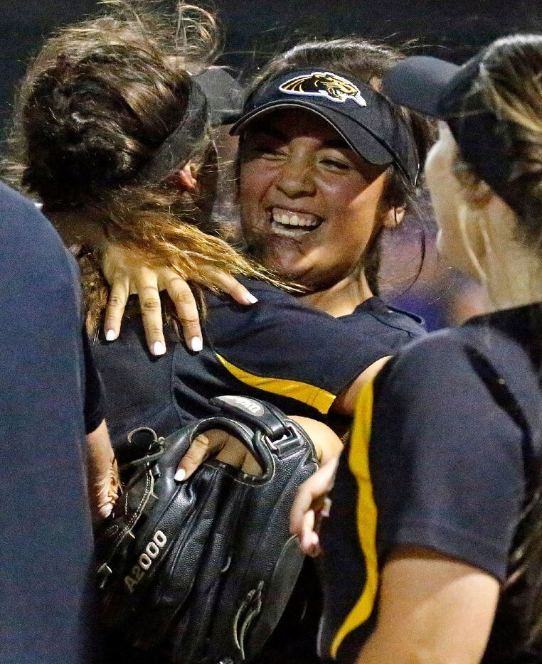 Plano East first baseman Gabbi Lopez (15) is embraced by second baseman Bella Konieczka (12) after the two completed a double play as Plano West High School hosted Plano East High School in softball game on, March 21, 2017. (Stewart F. House/Special Contributor)