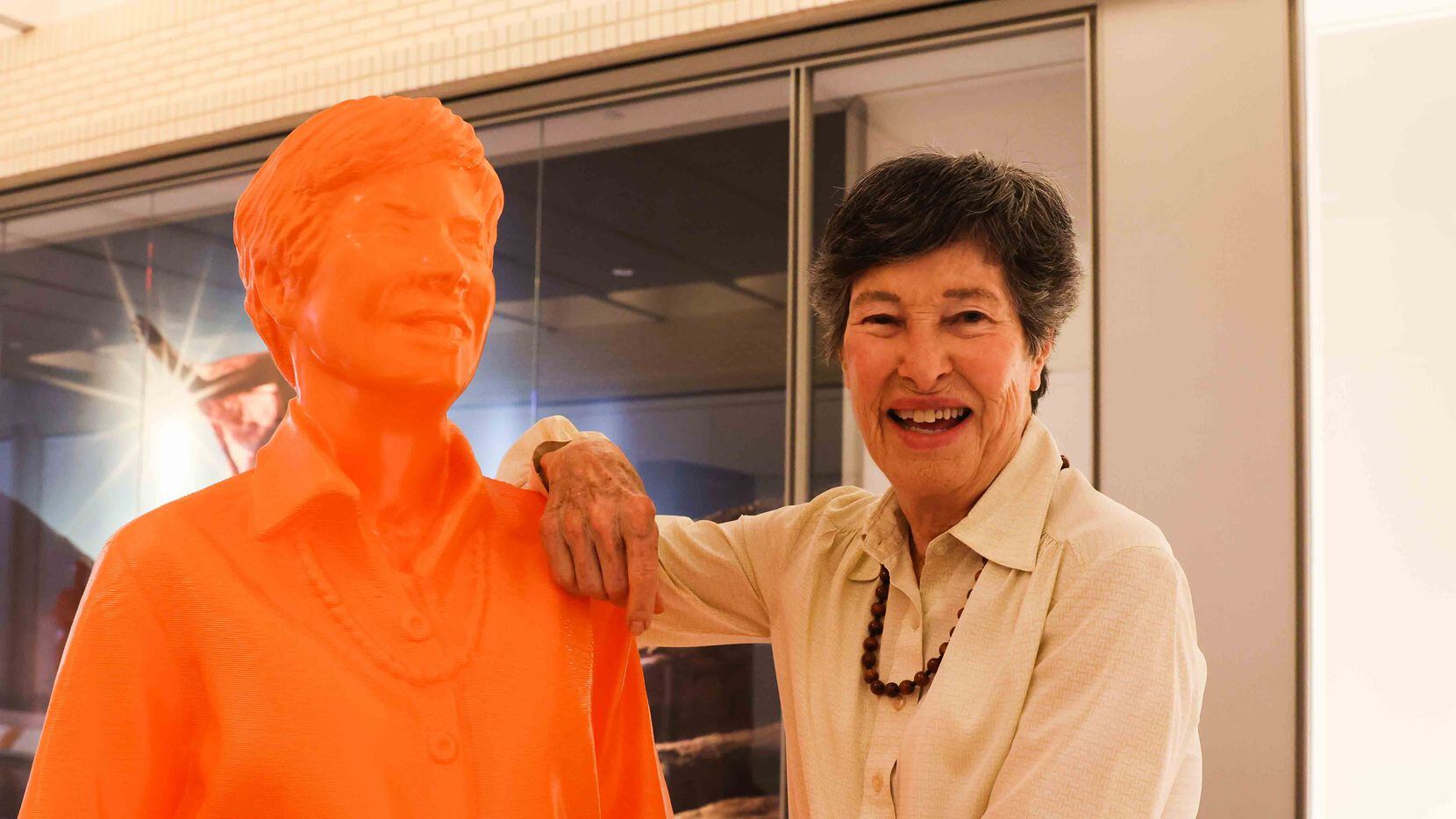 Lyda Hill, founder of LH Capital Inc., poses next to her own sculptures that is one of the...