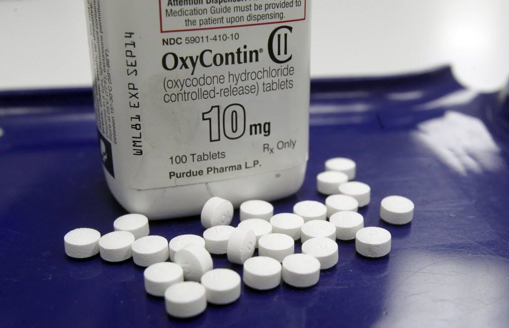 OxyContin pills, shown here at a Vermont pharmacy, are among the opioid drugs that a growing...