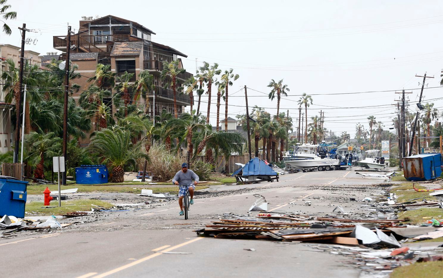 Mike Andrews rides his bike down the street after Hurricane Harvey hit Port Aransas, Texas on Aug. 26, 2017.