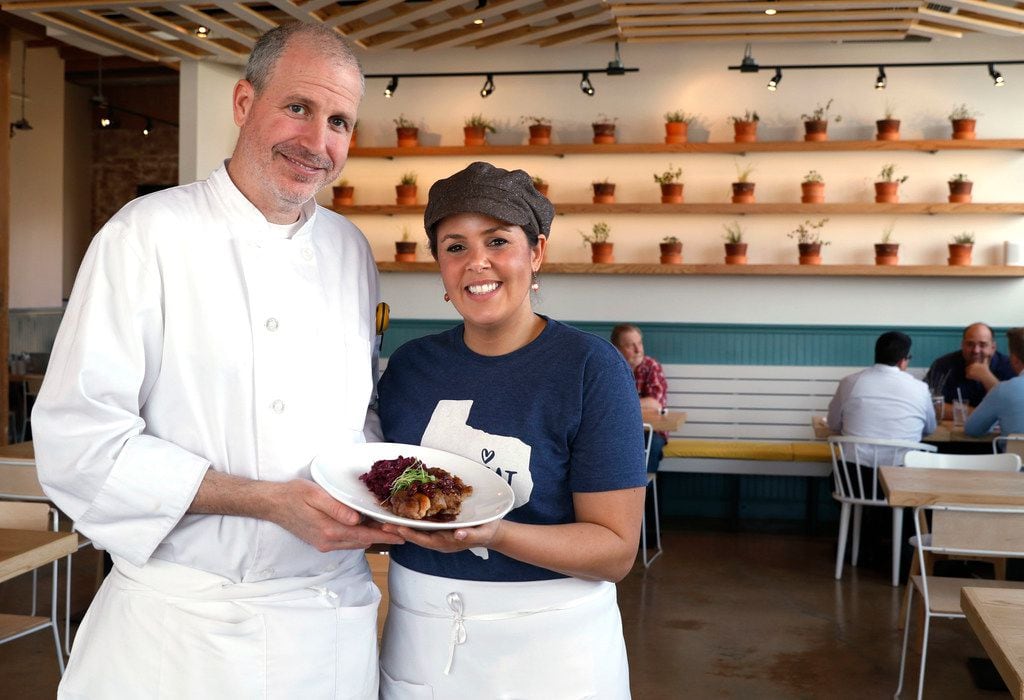 Jeff and Julie Williams hold a plate of duck scaloppini with red cabbage and cherry wine sauce in their new restaurant, Taste Community Restaurant in Fort Worth.