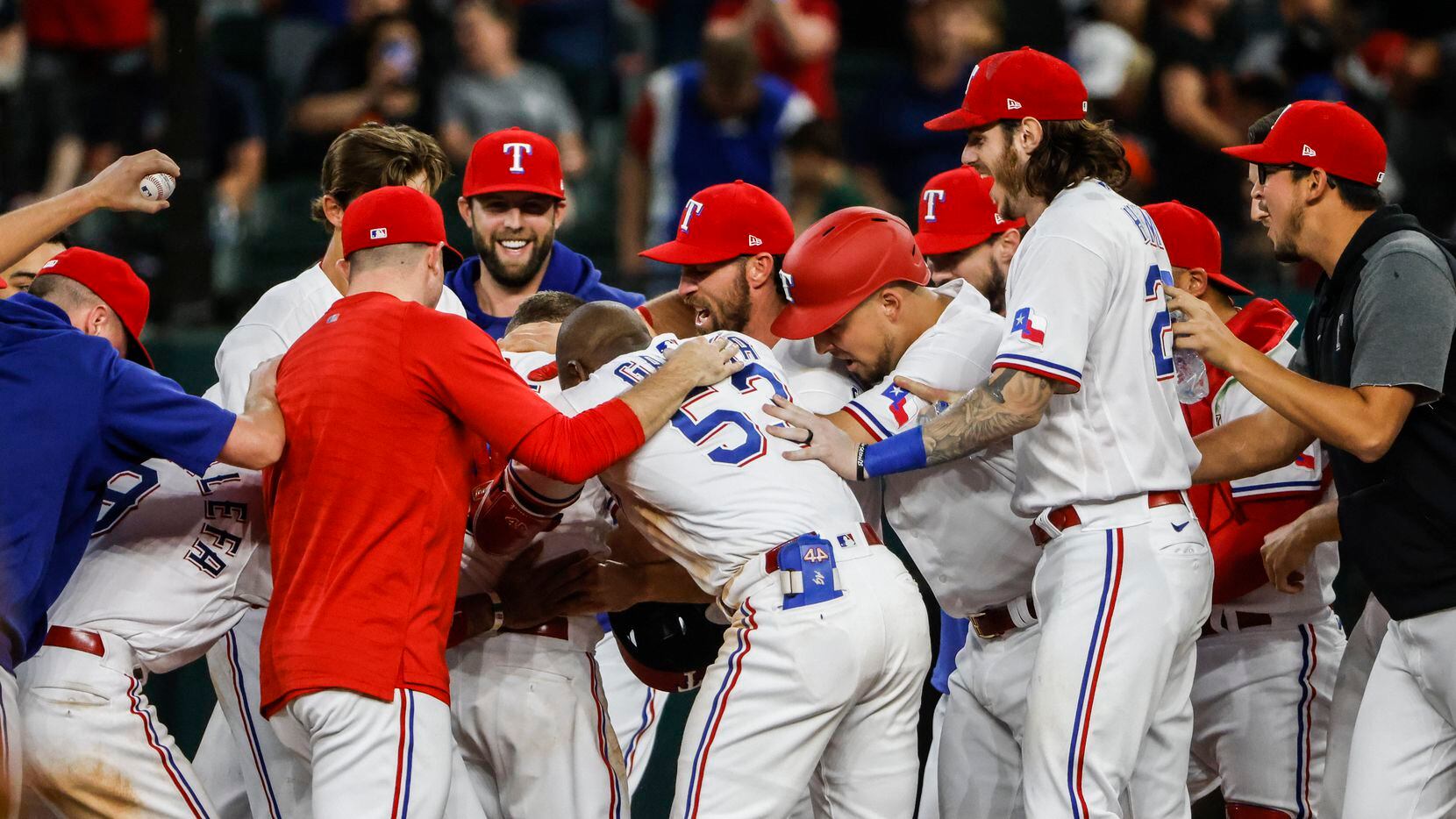 Texas Rangers celebrate after second baseman Brock Holt (16) singles out to centerfield, earning the Rangers a win in the bottom of the eleventh inning against the San Francisco Giants at Globe Life Field in Arlington, Texas, in Dallas on Wednesday, June 9, 2021.