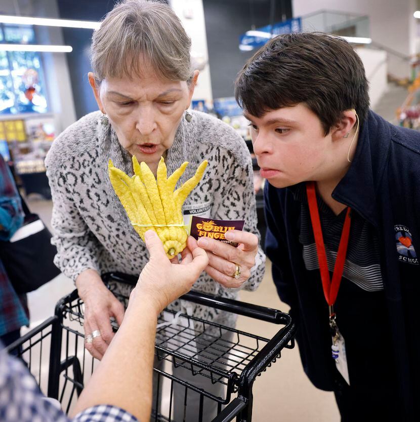 Jeanie Essl and Joshua, one of the four students on the grocery store outing Nov. 14, smell...