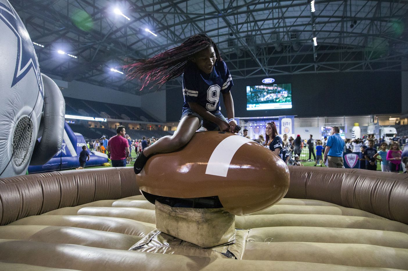 Laceon Donaldson, 11, rides a mechanical football during the Dallas Cowboys' 2017 NFL Draft Party on Friday, April 28, 2017, at The Star in Frisco.
