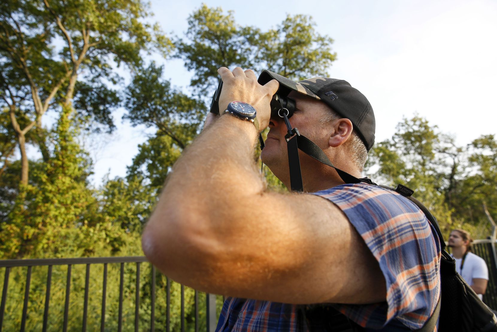 Master Naturalist Ben Sandifer scans the trees for birds while giving a guided nature tour...