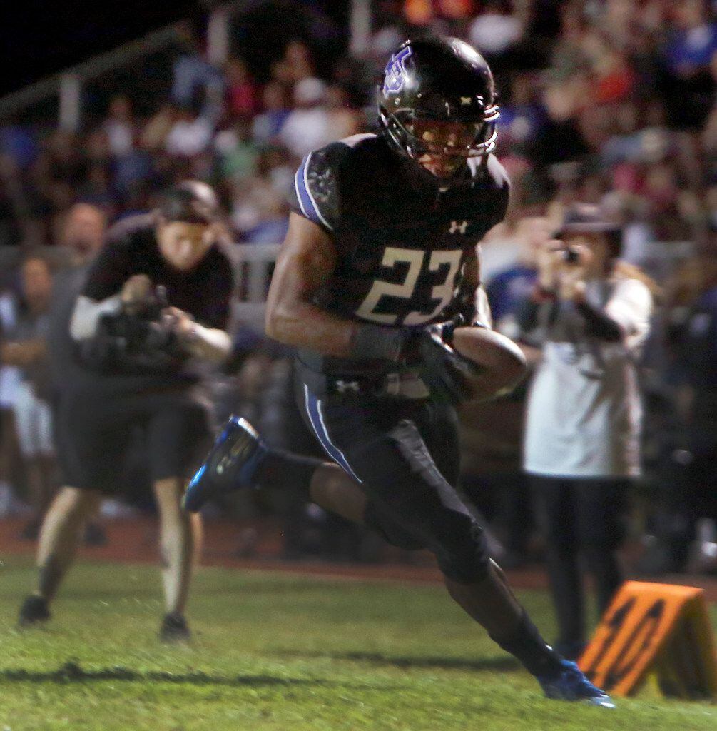 Trinity Christian running back Dez Moultrie (23) tightropes the sideline into the end zone...