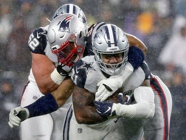 New England Patriots defensive end Deatrich Wise (91) tackles Dallas Cowboys running back Ezekiel Elliott (21) during the first half at Gillette Stadium in Foxborough, Massachusetts Sunday, November 24, 2019. (Tom Fox/The Dallas Morning News)