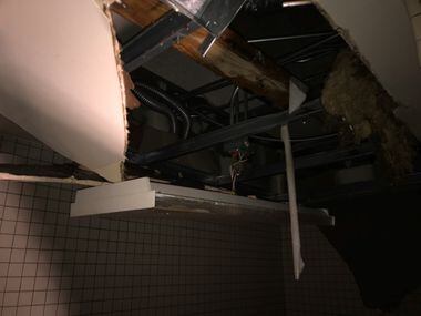 A photo shows heavy damage to the ceiling in a basement bathroom in Dallas' Hall of State on...
