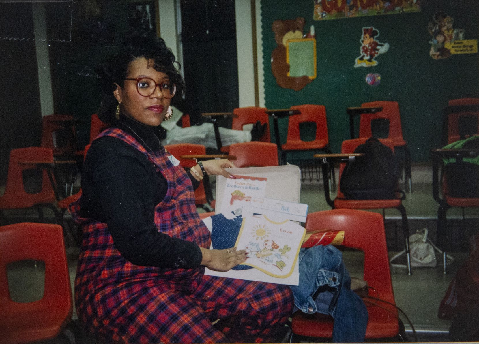 Donna Fields, who became pregnant by her boyfriend when she was 16, holds gifts from Rickie Rush during a baby shower he threw for her in his classroom at Skyline High School. After she gave birth to her son in 1991, she said, Rush gave her money — for a bassinet, clothes, rent and a car.