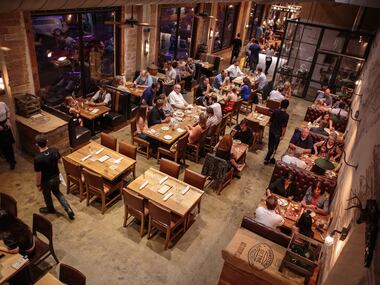 People enjoy their meals in the back dining room at Barley and Board's soft opening event on...