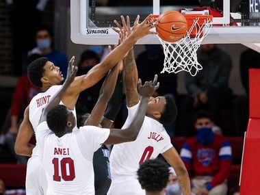 (L to R) SMU forwards Feron Hunt, Yor Anei (10) and guard Tyson Jolly (0) vie for a rebound during the second half of a college basketball game against Memphis in Dallas, Thursday, January 28, 2021. SMU won 67-65.