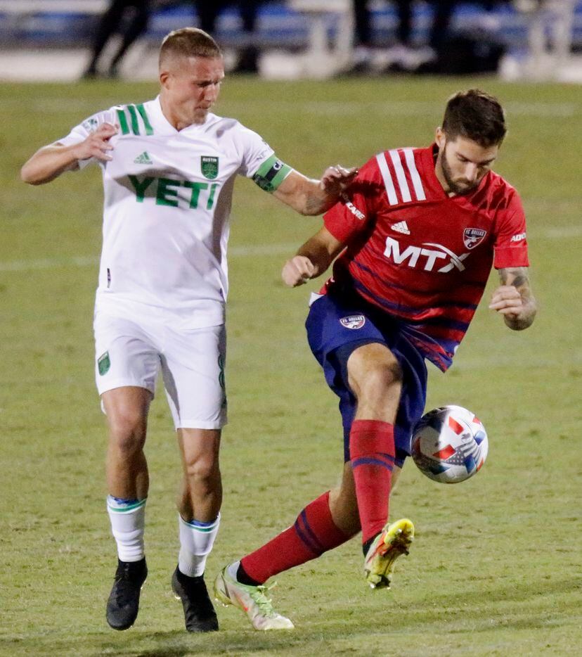 FC Dallas midfielder Ryan Hollingshead (12) is shoved by Austin FC midfielder Alexander Ring (8) during the second half as FC Dallas hosted Austin FC at Toyota Stadium in Frisco on Saturday, October 30, 2021. (Stewart F. House/Special Contributor)