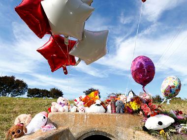 A growing memorial in the area where the body of a small child was found Sunday morning...
