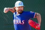 Texas Rangers pitcher Kirby Yates throws in the bullpen during a spring training workout at...