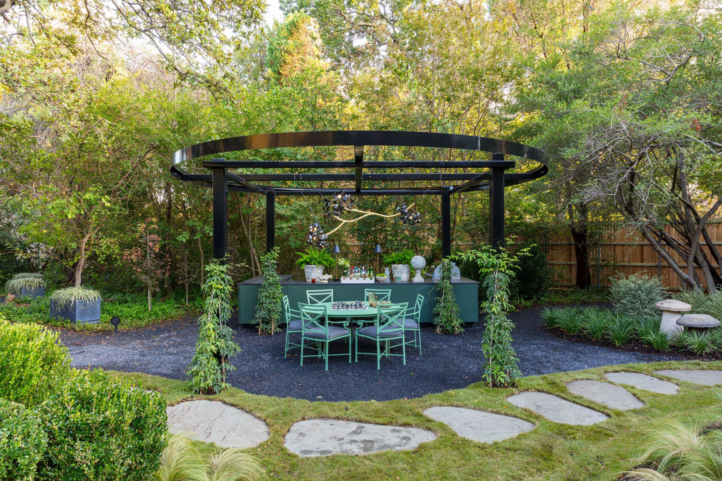 In the dining pergola designed by From the Ground Up, find a custom chandelier,  a Brown...