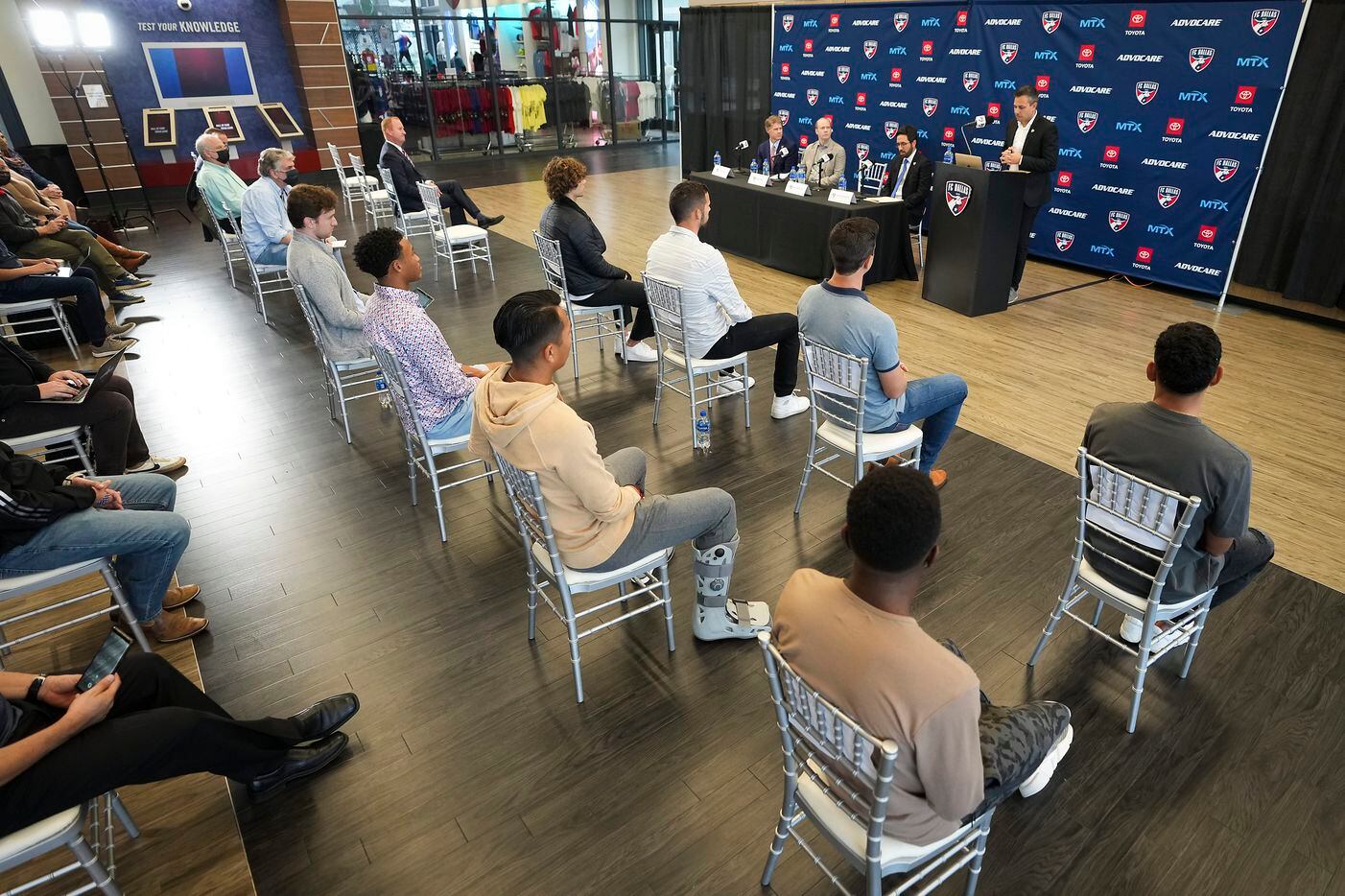 A group of FC Dallas players listen as new head coach Nico Estévez addressed his introductory press conference at the National Soccer Hall of Fame on Friday, Dec. 3, 2021, in Frisco, Texas.