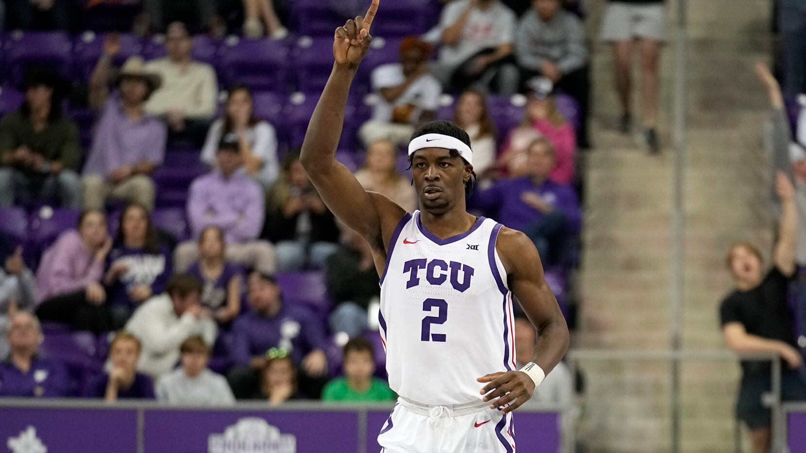 TCU forward Emanuel Miller (2) celebrates sinking a three-point shot in the second half of...