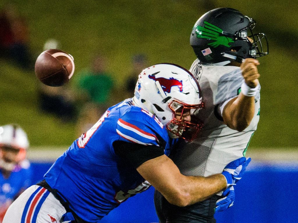 Southern Methodist Mustangs defensive end Justin Lawler (99) sacks North Texas Mean Green quarterback Mason Fine (6) during the third quarter of a football game between UNT and SMU on Saturday, September 9, 2017 at SMU's Ford Stadium in Dallas. (Ashley Landis/The Dallas Morning News) 

