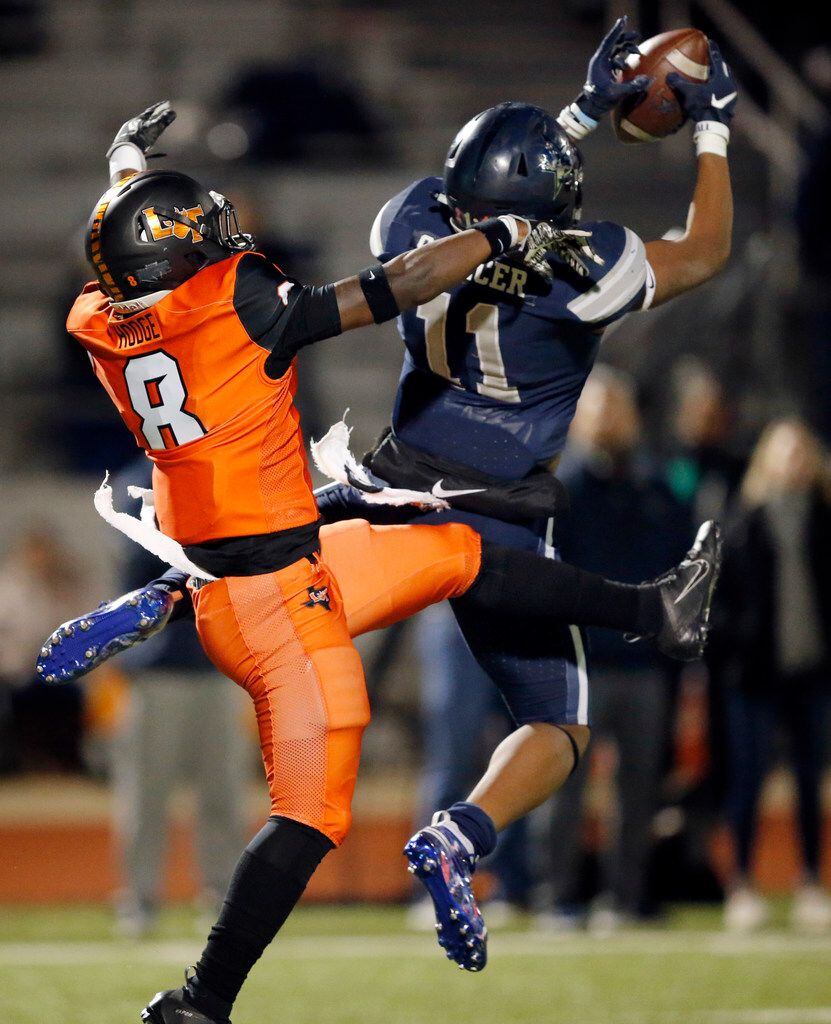 Frisco Lone Star Lancaster wide receiver Brandon Spencer makes an acrobatic catch before taking the completion in for a second quarter touchdown against Lancaster defensive back Davion Hodge (8). The score was during their Class 5A Division I Regional championship at Wilkerson-Sanders Stadium in Rockwall, Texas, Friday, December 6, 2019. (Tom Fox/The Dallas Morning News)