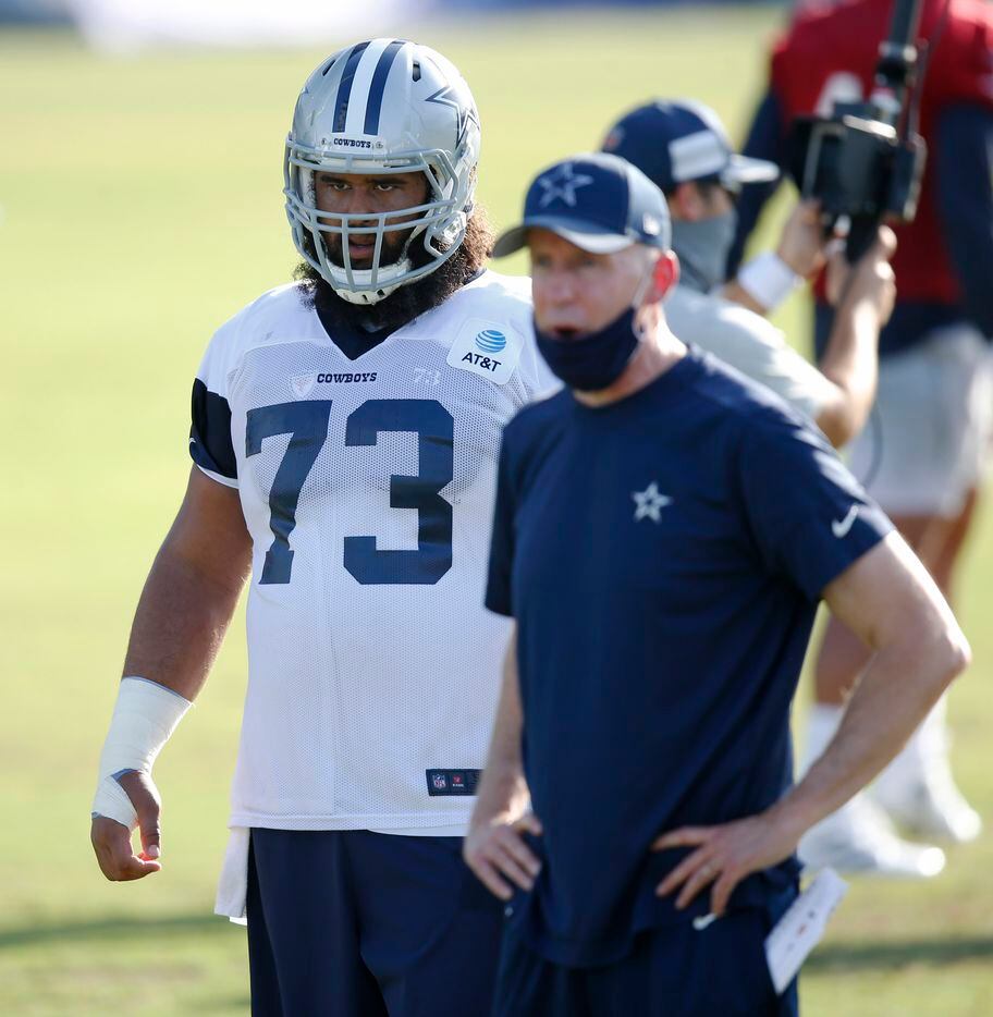 Dallas Cowboys center Joe Looney (73) watches practice during the first day of training camp...