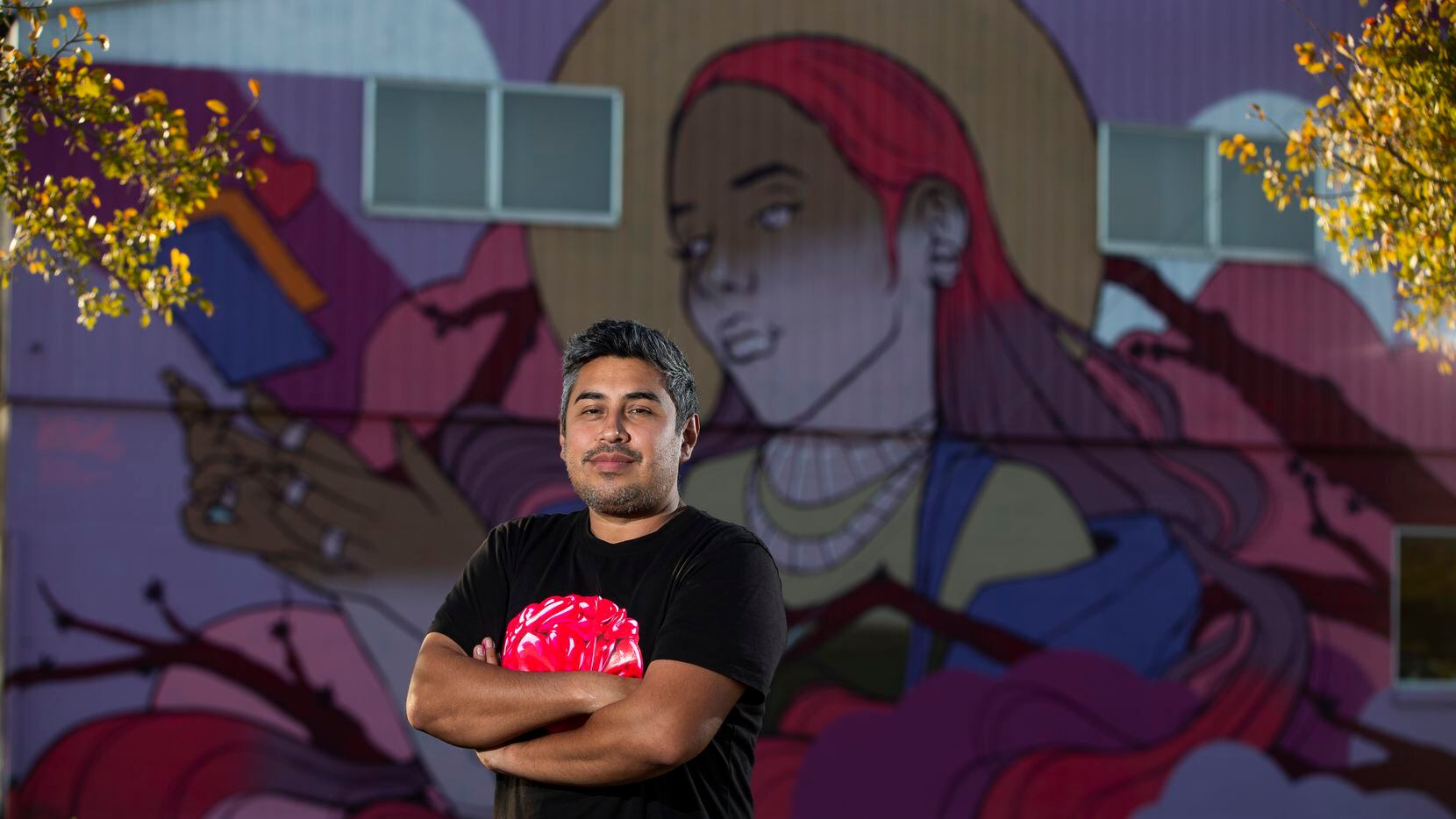 Hatziel Flores posed in front of his mural in West Dallas on Nov. 16, 2021. Street art...