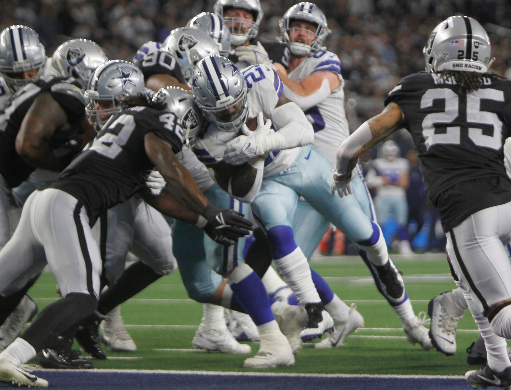 Dallas Cowboys running back Ezekiel Elliott (21), powers his way past Las Vegas Raiders outside linebacker Cory Littleton (42) into the end zone for a 2nd quarter rushing touchdown. The two NFL teams played their Thanksgiving Day game at AT&T Stadium in Arlington on November 25, 2021. (Steve Hamm/ Special Contributor)
