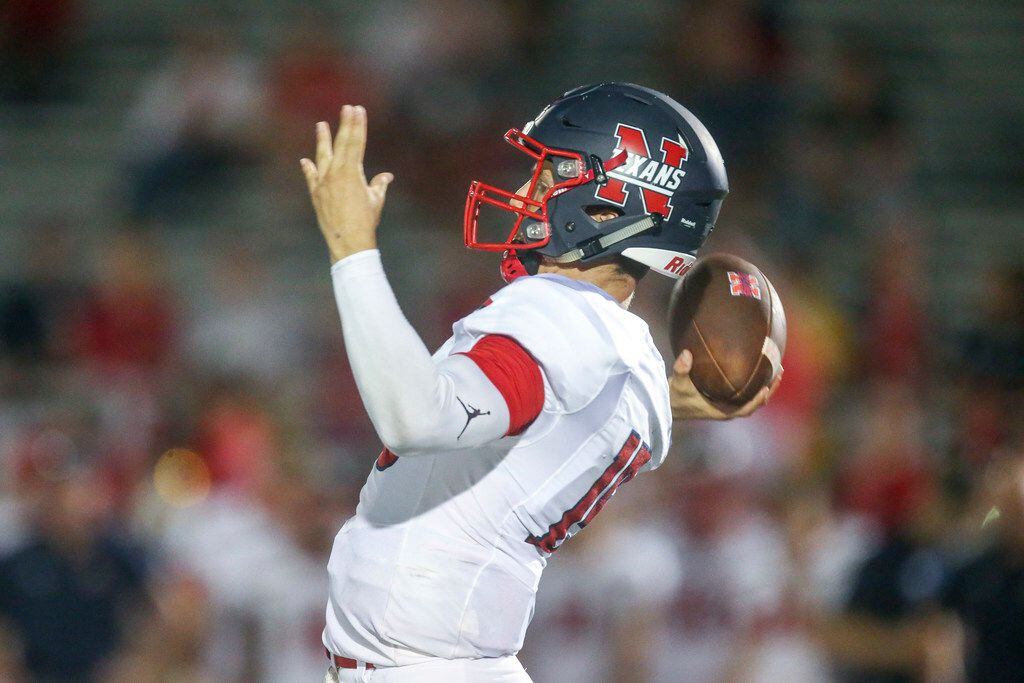 Northwest quarterback Austin Ahmad (15) makes a pass during the second half of a high...