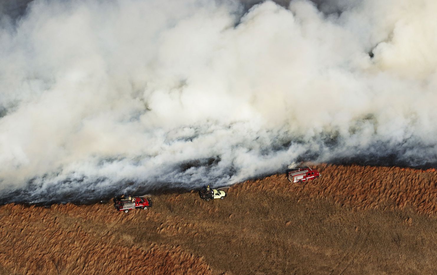 Fire crews tried to control a grass fire west of Fort Worth, Texas, on Monday January 22,...