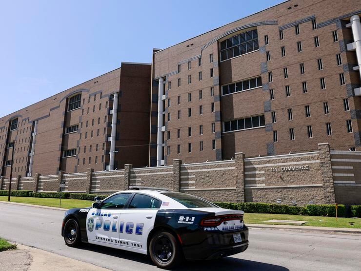 A Dallas police patrol car drives along Commerce Street outside the Dallas County jail in...