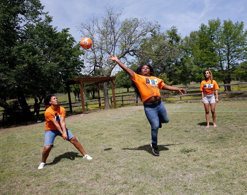 Ida H. (left) and Lauryn Reeder move to hit the ball during a game of volleyball at the picnic.