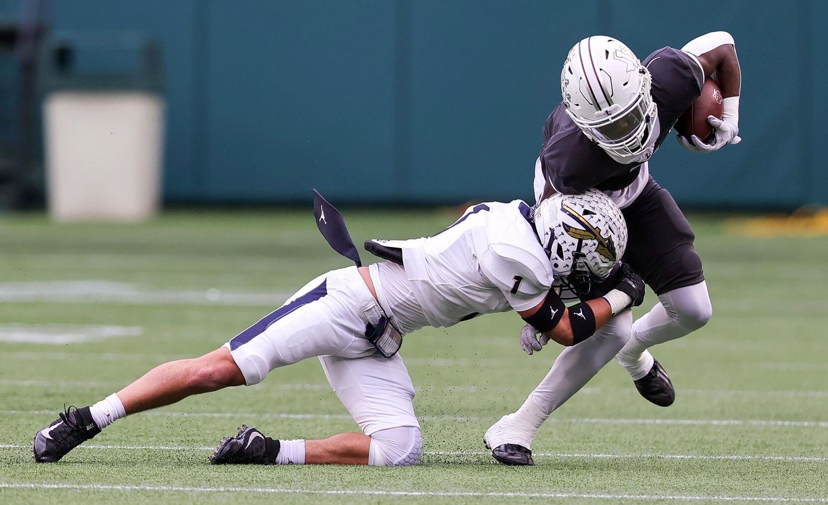 Lewisville wide receiver Lamar Kerby, (right) comes up with a reception and is brought down...