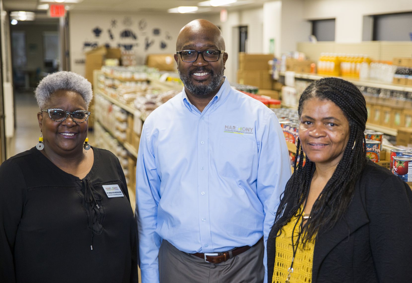 From left: Dr. Brenda Richardson Rowe joins Executive Director Mark Porter and Program Director Candy Bradshaw in the food pantry at Harmony Community Development Corp.