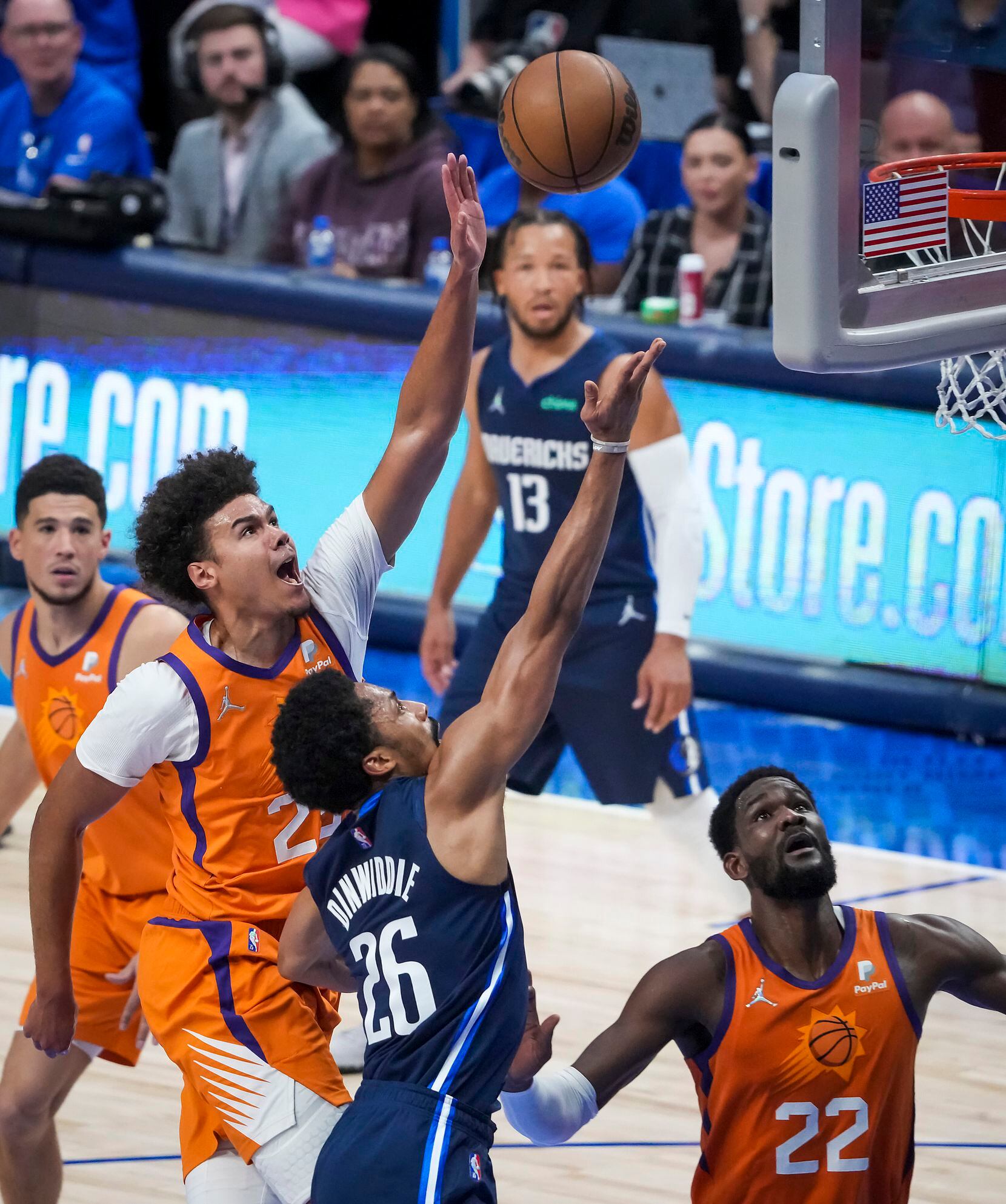 Dallas Mavericks guard Spencer Dinwiddie (26) puts up a shot as Phoenix Suns forward Cameron...
