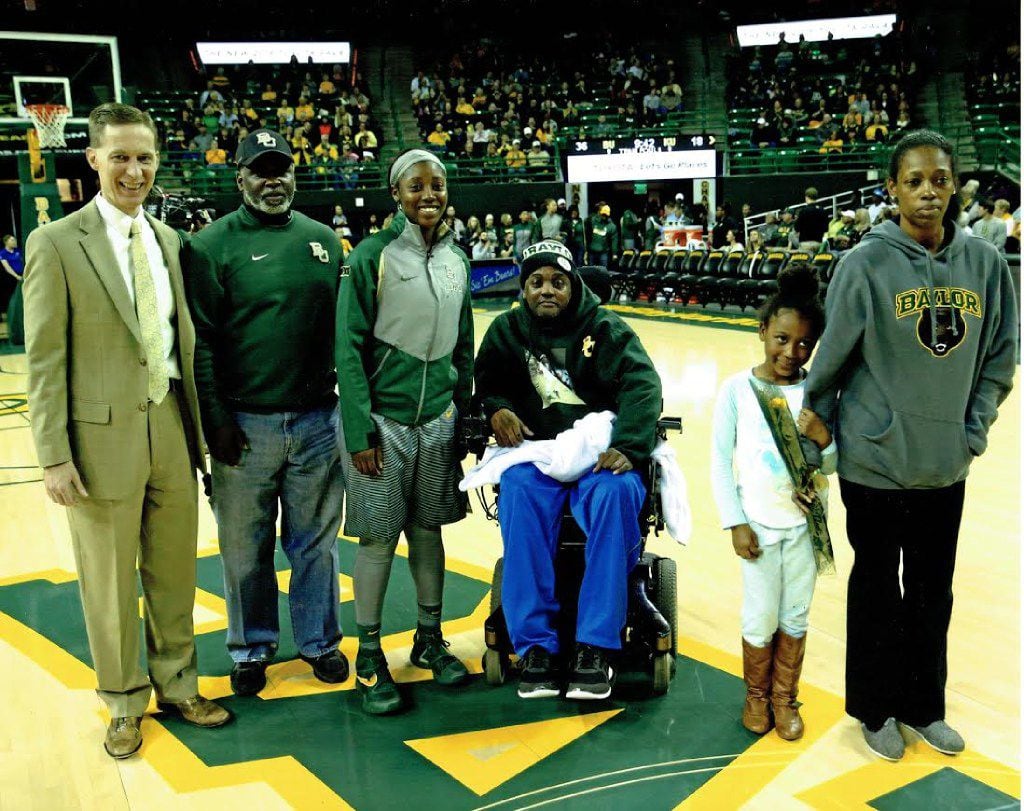 Alexis Jones with her family on the court at a Baylor basketball game