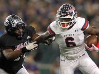 Denton Ryan running back Anthony Hill Jr. (6), right, tries to elude College Station...