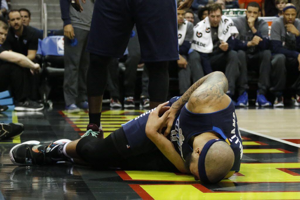 Mavericks guard Deron Williams lays on the floor with a hip injury against the Atlanta Hawks...