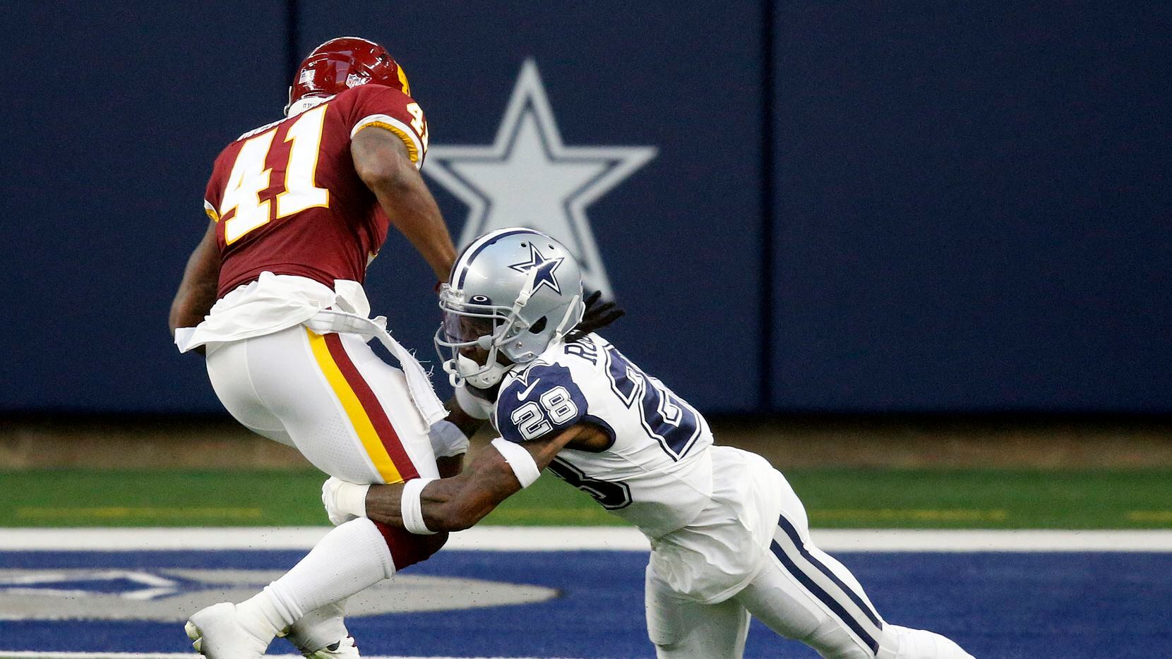 Dallas Cowboys defensive back Rashard Robinson (28) attempts to tackle Washington Football...