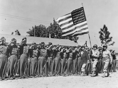 It's "Present arms!" for members of the 442nd Regimental Combat Team, Japanese-American...