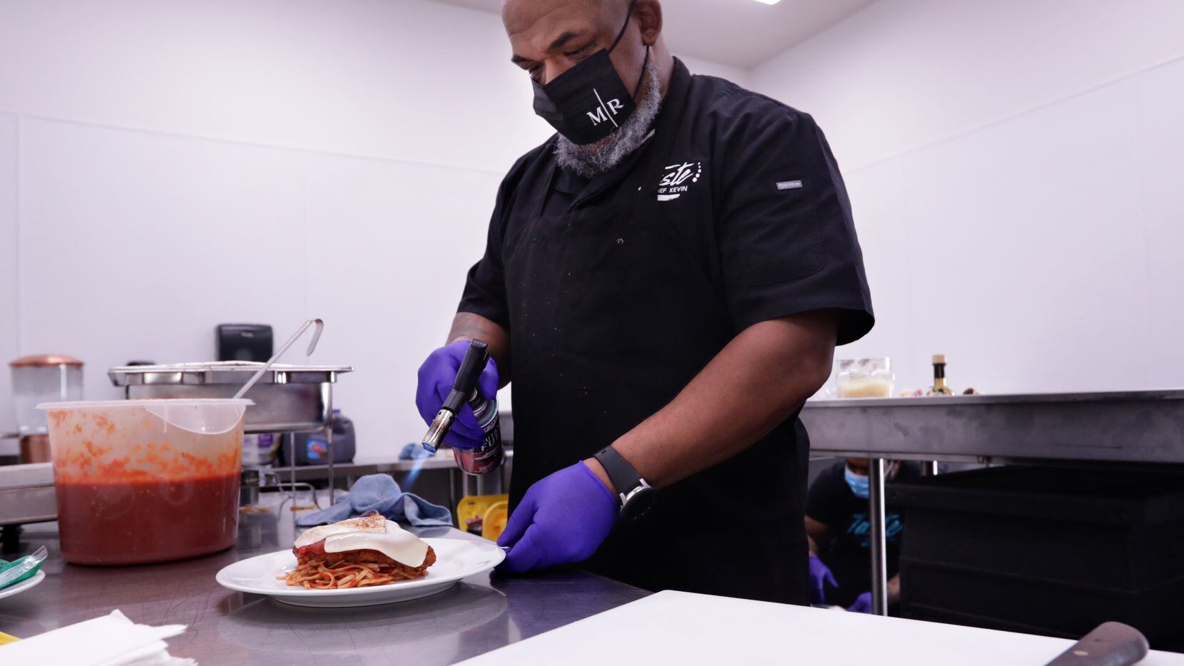 Kevin Johnson prepares food for a wedding reception at Knotting Hill Place in Little Elm.