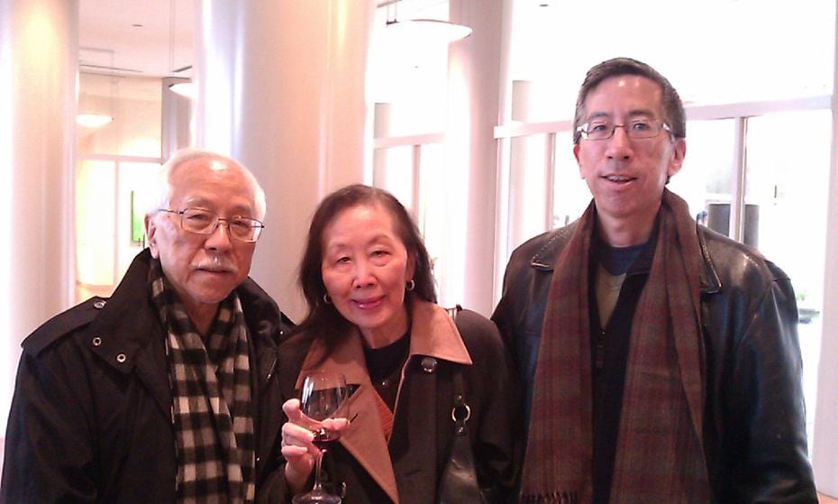 Thomas Huang (right) in an undated photograph with his parents.
