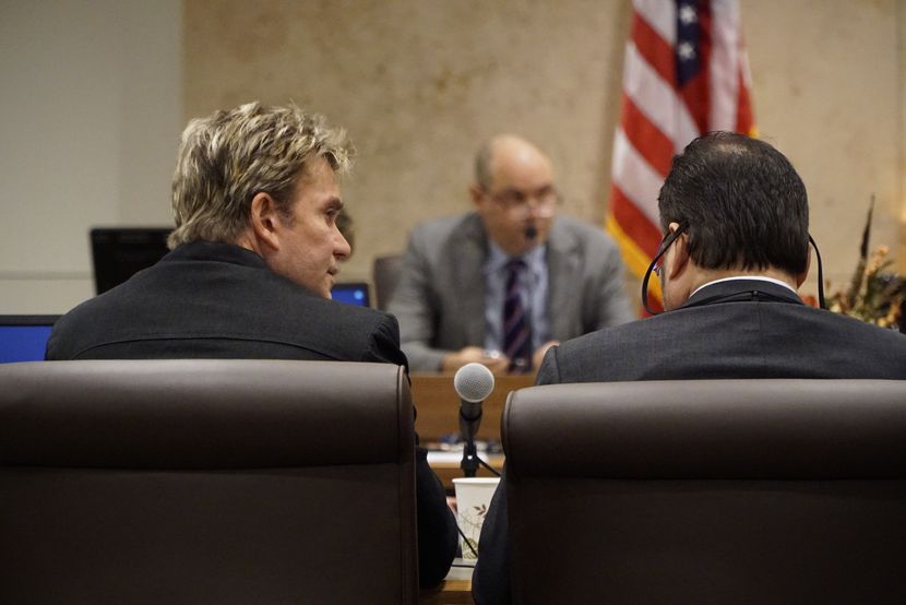 Vic Mignogna, left, sits beside attorney Ty Beard during a hearing in the 141st state...
