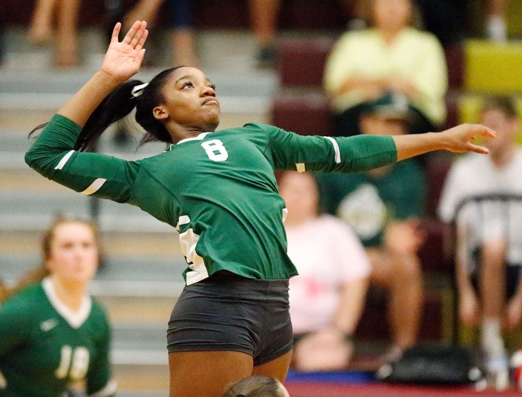 Lebanon Trail High School middle blocker Tyrah Ariail (8) goes up for a hit during game...