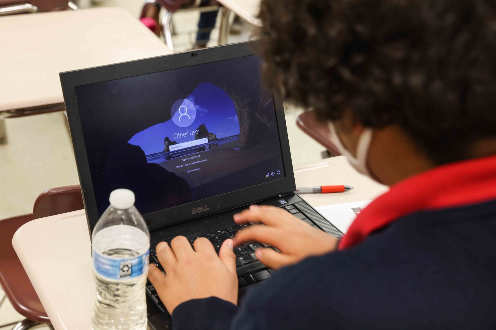 Student Francisco Gallegos tries several times to connect on a laptop during class at...